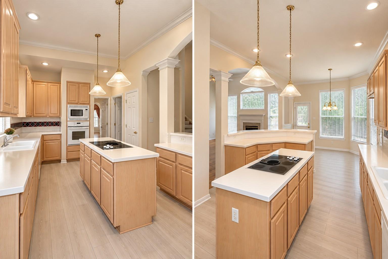Kitchen with light wood cabinetry, white counters, and a central cooktop island beside a bright living area.