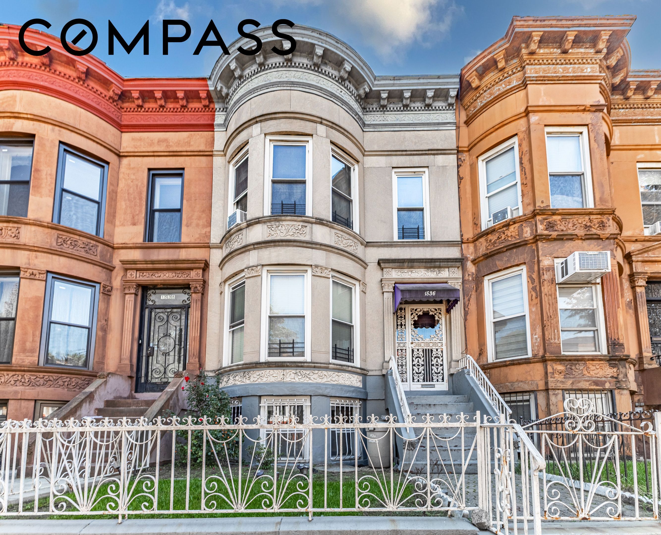 Ornate adjoining townhouses with curved bay windows, decorative facades, and a white wrought-iron fence.