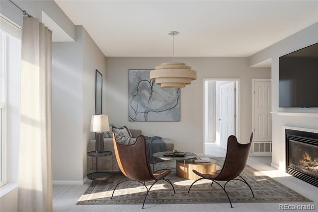 Living room with brown leather chairs, abstract wall art, and a fireplace beside tall curtained windows.