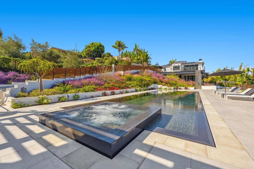 Luxury outdoor patio with modern water feature and landscaped garden