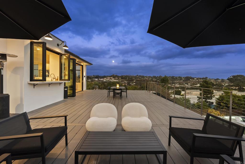 Modern rooftop deck with lounge seating and expansive city views