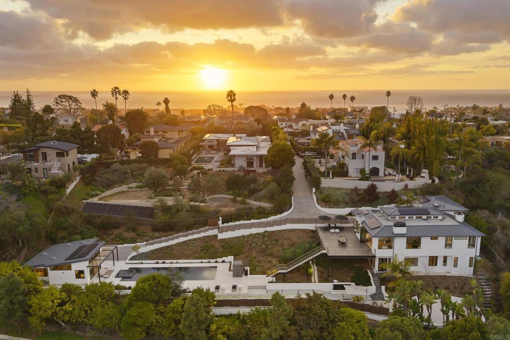 Sunset aerial view of coastal neighborhood with luxury homes