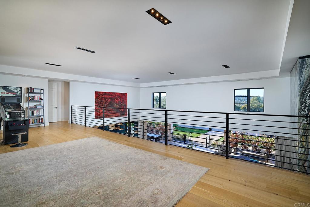 Open upstairs landing with carpet and modern railing design