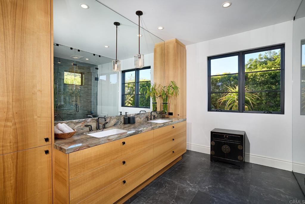 Contemporary double vanity bathroom with natural wood cabinetry