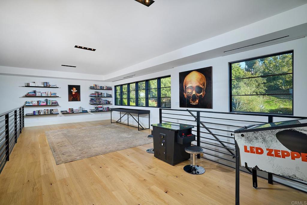Loft-style bonus room with custom railing and large windows
