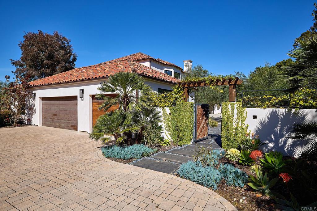 Garden pathway surrounded by tropical plants and outdoor seating