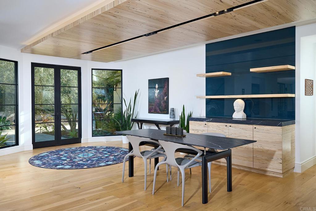 Contemporary dining and lounge area with wood ceiling accents