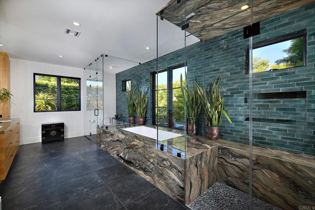 Luxury spa bathroom with stone flooring and walk-in shower