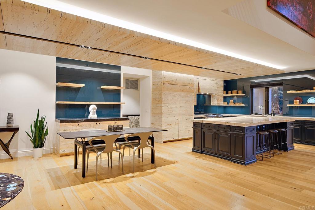 Luxury open kitchen and dining room with hardwood flooring