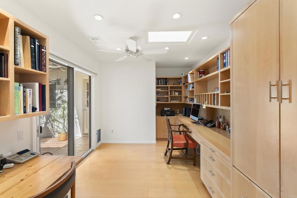 Spacious home office with built-ins and backyard access