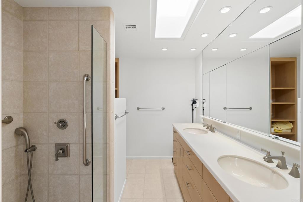 Remodeled bathroom with walk-in shower and double vanity
