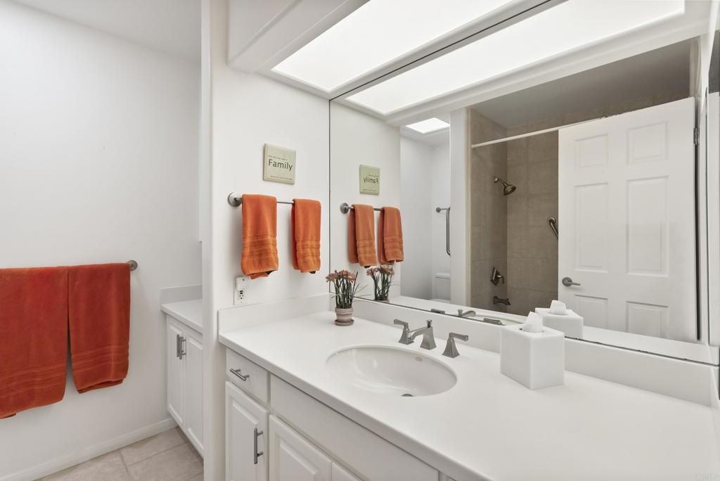 Dual-sink bathroom with large mirror and neutral finishes
