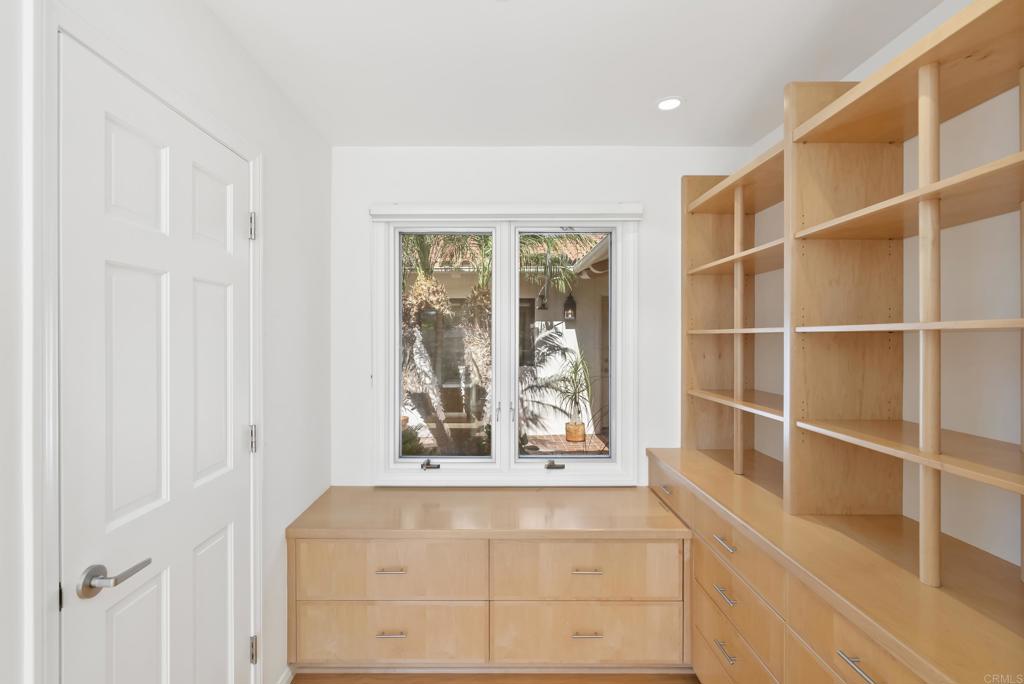 Custom built-in office cabinetry with window overlooking greenery