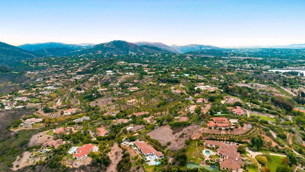 Panoramic aerial shot showcasing homes, hills, and open terrain in Rancho Santa Fe