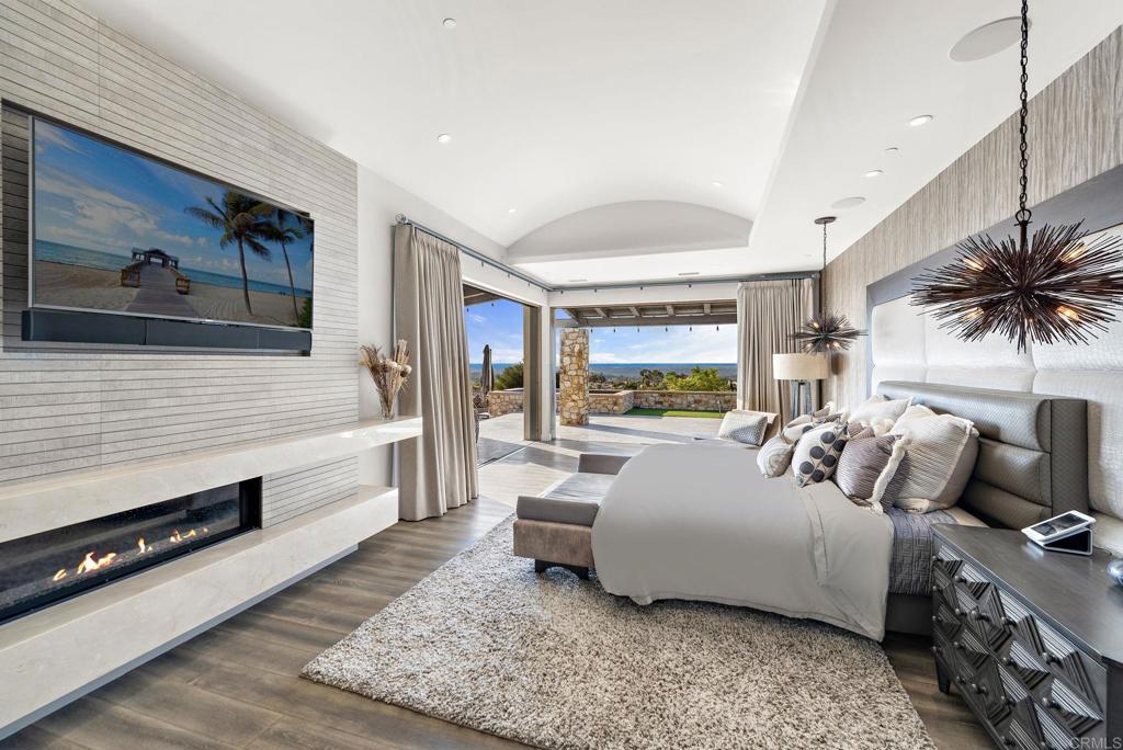 Primary bedroom suite with balcony and sunset views