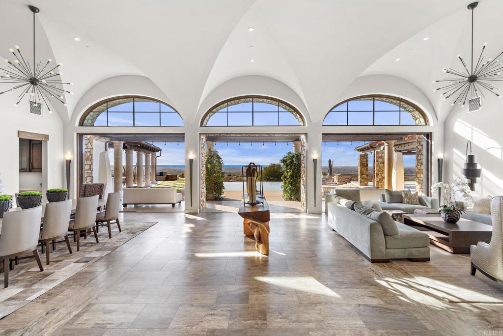 Great room with soaring arched windows and golf course views