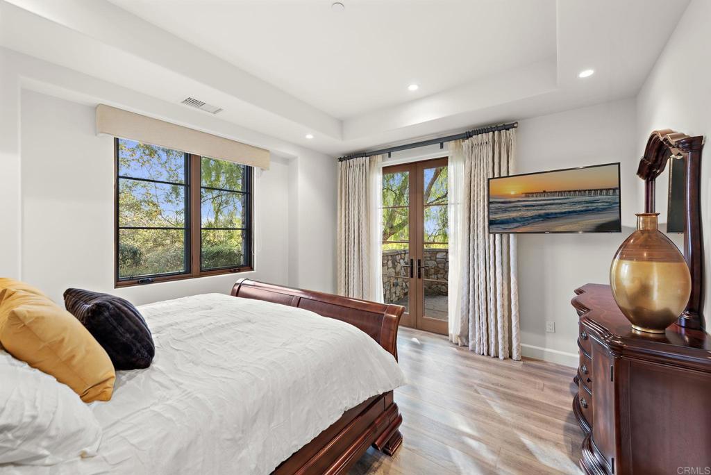 Guest bedroom with large windows and neutral decor