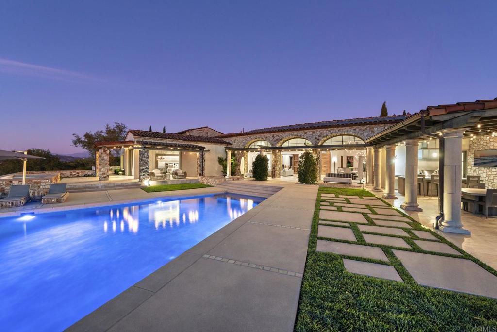 Twilight poolside view of Santaluz luxury home