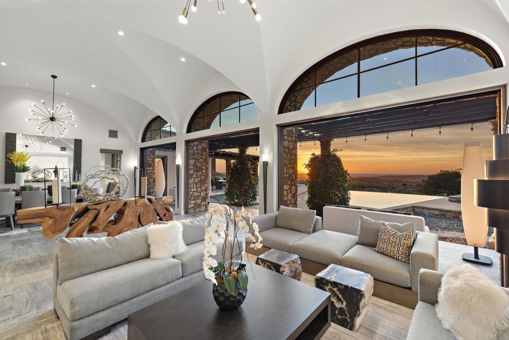 Elegant living room with sunset views through arched windows