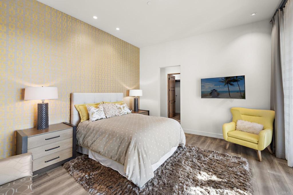 Luxury bedroom with custom accent wall and modern furnishings