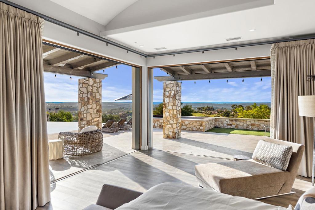 Covered outdoor lounge area with panoramic mountain views