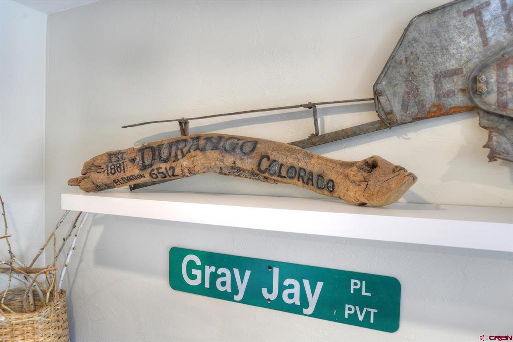 Driftwood marked Durango Colorado above a green Gray Jay street sign.