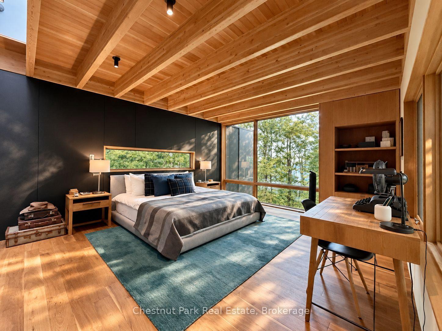 Modern bedroom with a vaulted wood ceiling, large windows, and a glimpse of water through the trees.