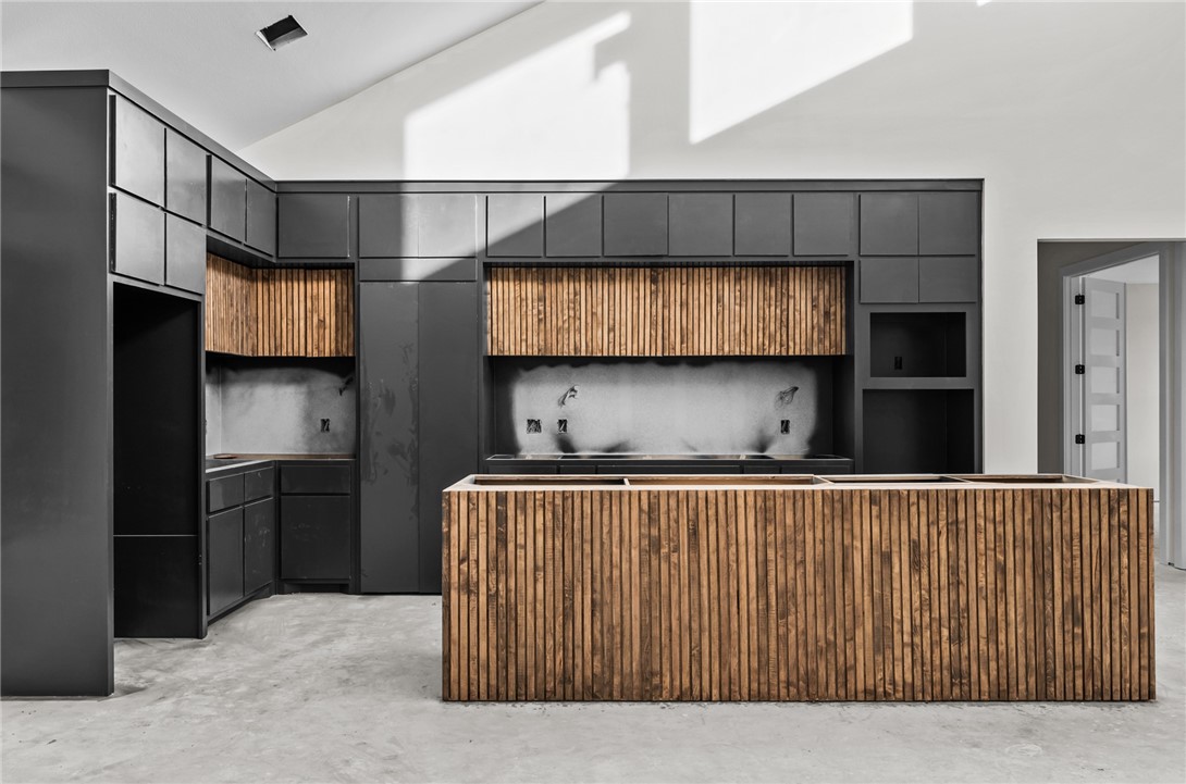 Kitchen island, hidden pantry and cabinetry in a new construction home in Kings Landing Corpus Christi built by Jade Homes