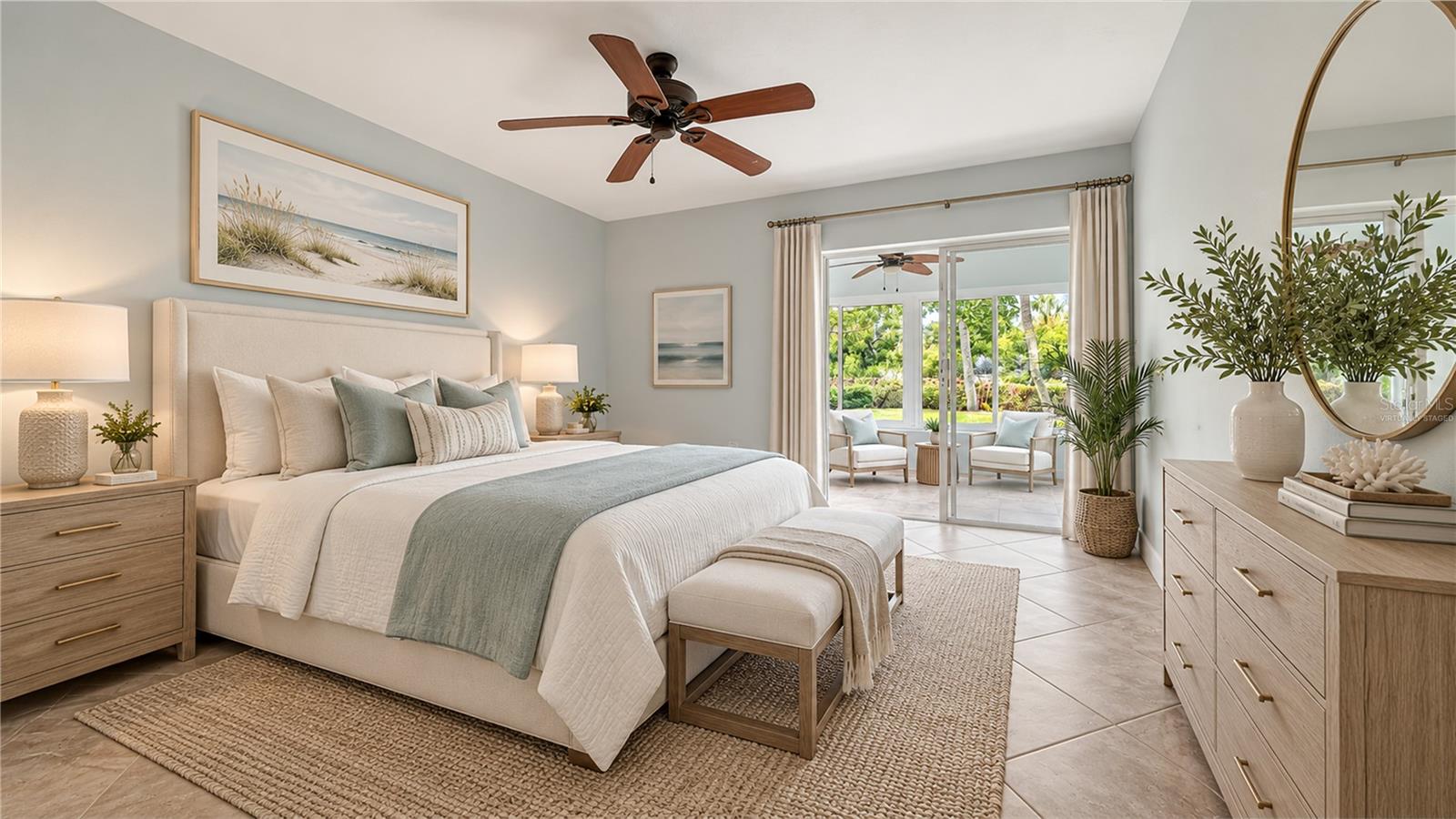 Bedroom with a king bed and sliding doors opening to a patio and tropical greenery.