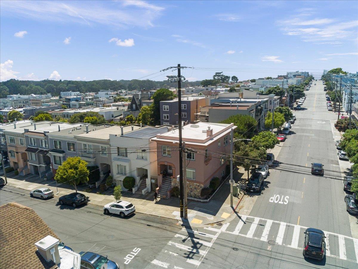 Pink multi-story corner building at a San Francisco intersection, viewed from above.