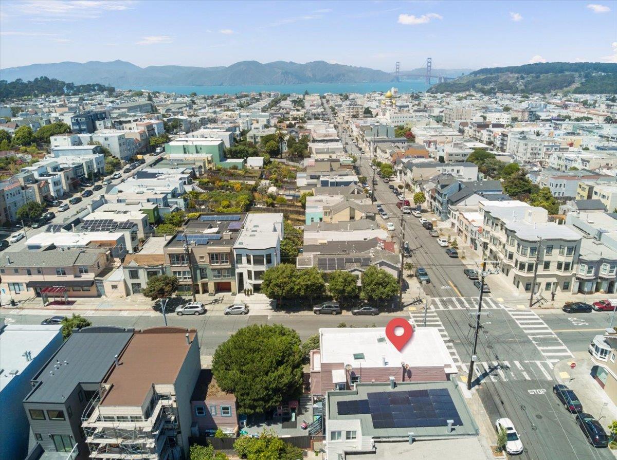 Aerial view of San Francisco homes, with the bay and Golden Gate Bridge in the distance.