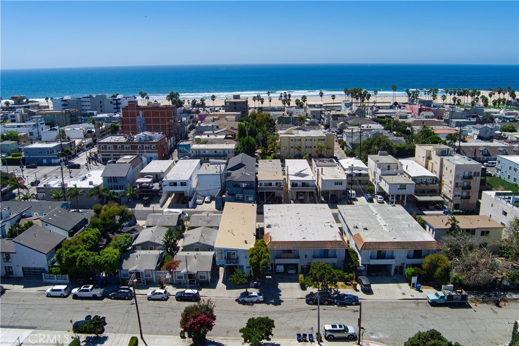 Aerial view of coastal homes in Venice, with the beach and Pacific Ocean beyond.