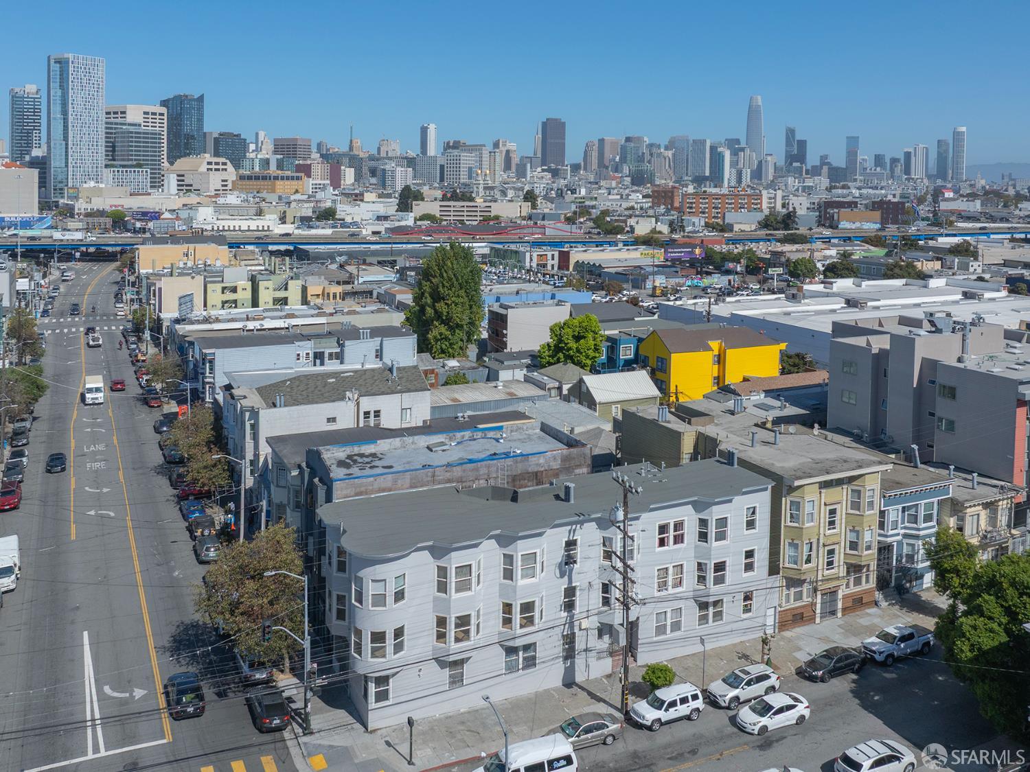 San Francisco rooftops and residential street with the downtown skyline in the distance.