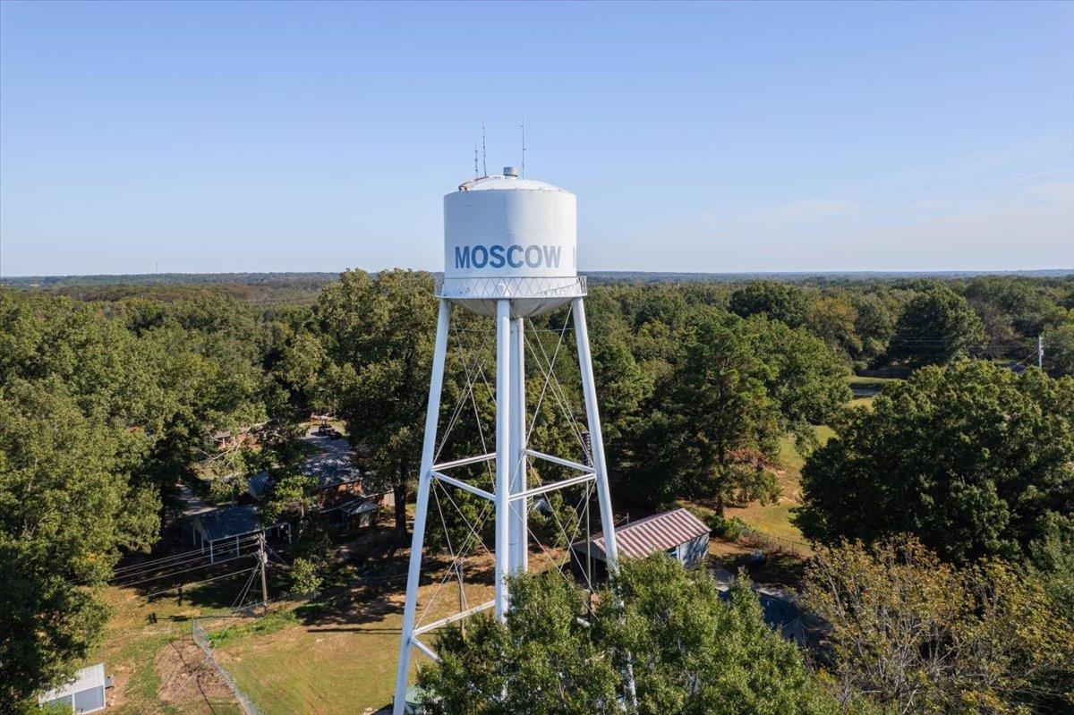 Moscow water tower rising above a tree-lined landscape.