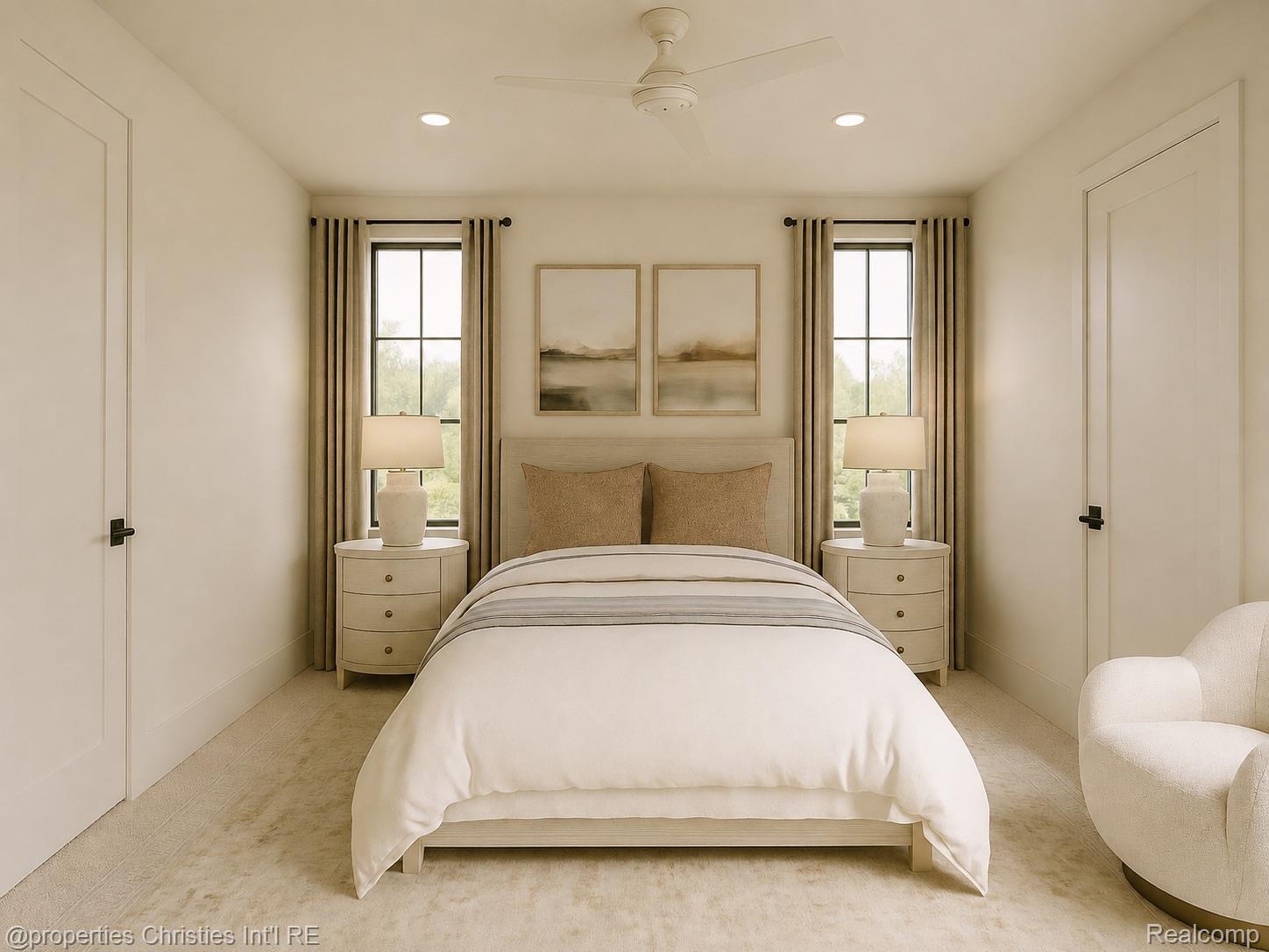 Staged bedroom with a centered bed between two tall windows and matching bedside tables.