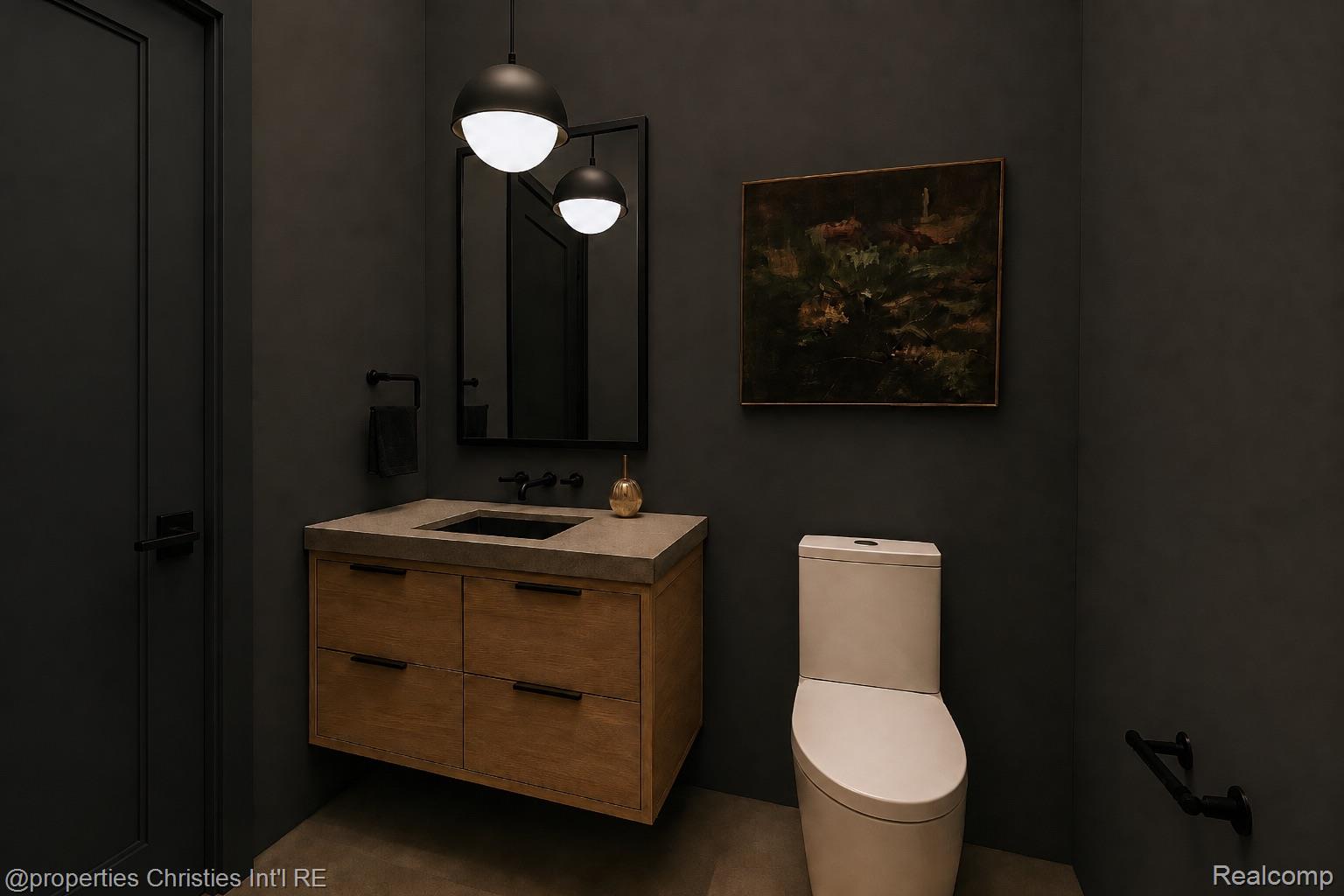 Dark modern bathroom with a floating wood vanity, pale stone counter, and white toilet.