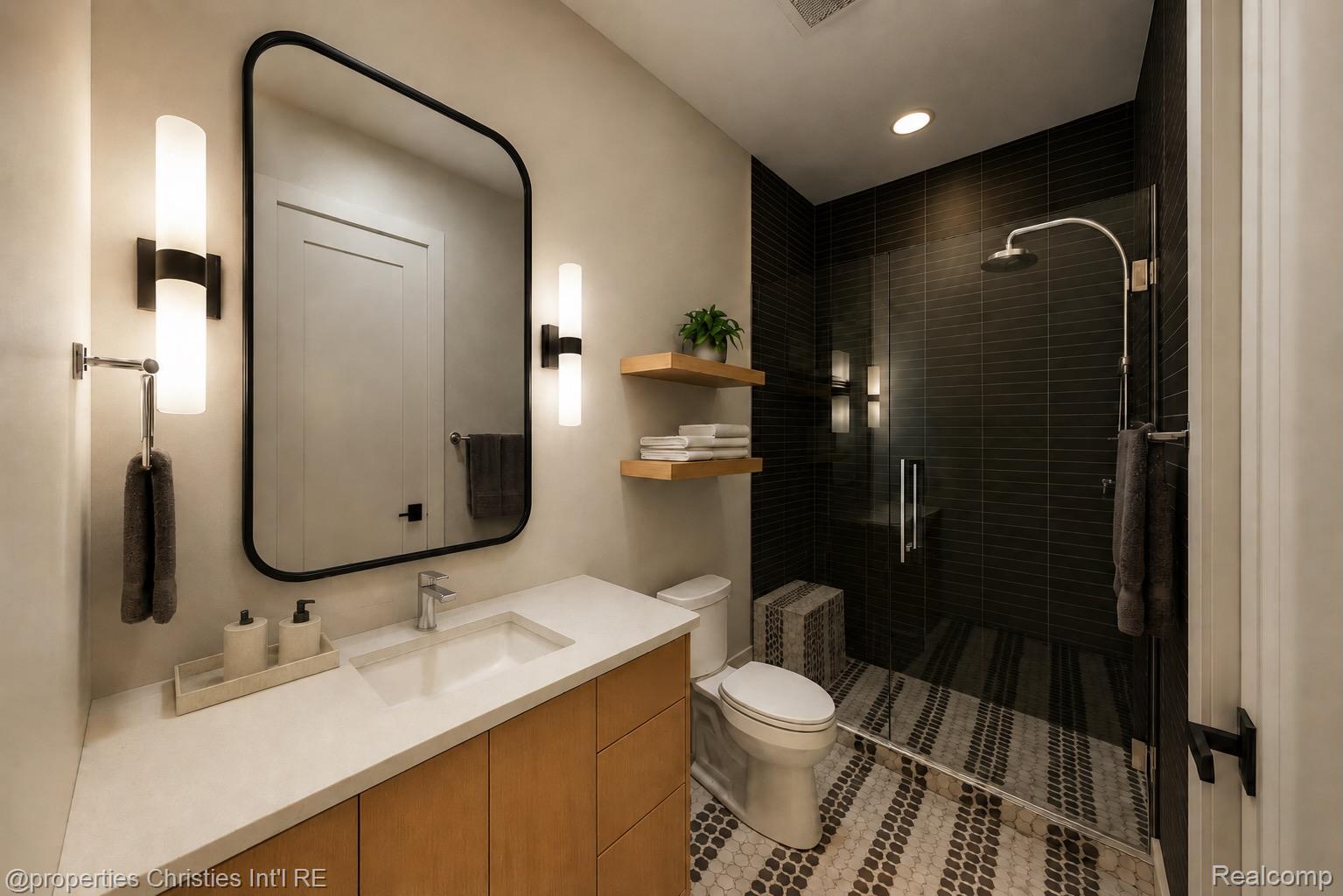 Contemporary bathroom with a wood vanity, black-framed mirror, and dark-tiled glass shower.