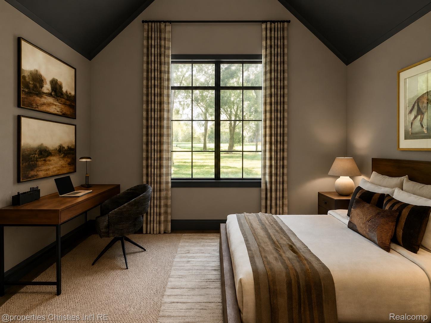 Furnished bedroom with a vaulted ceiling, large window overlooking a lawn, and a desk beside the bed.