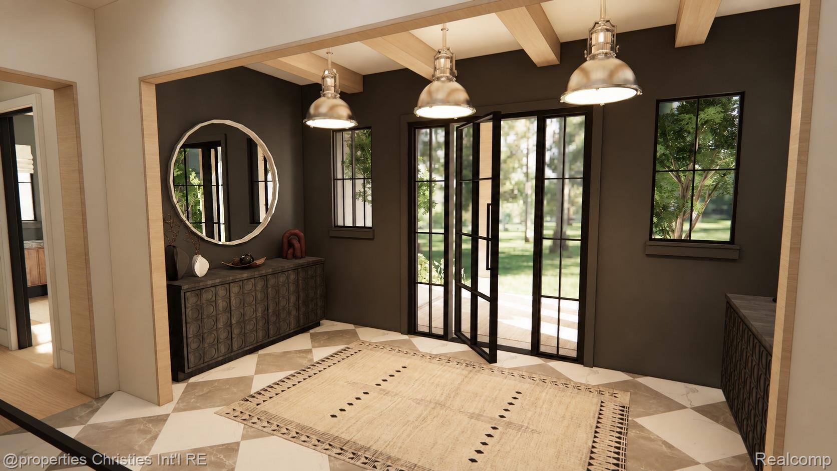 Foyer with exposed wood beams, a round mirror, patterned console, and glass doors opening to the lawn.