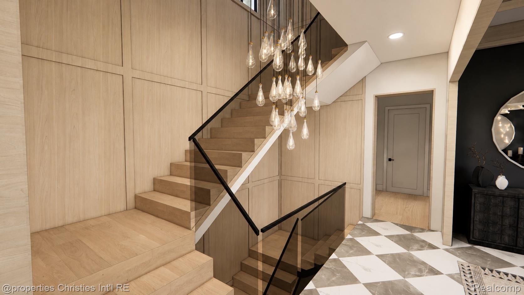 Foyer with a sculptural wood staircase, black railings, pendant lights, and geometric marble flooring.