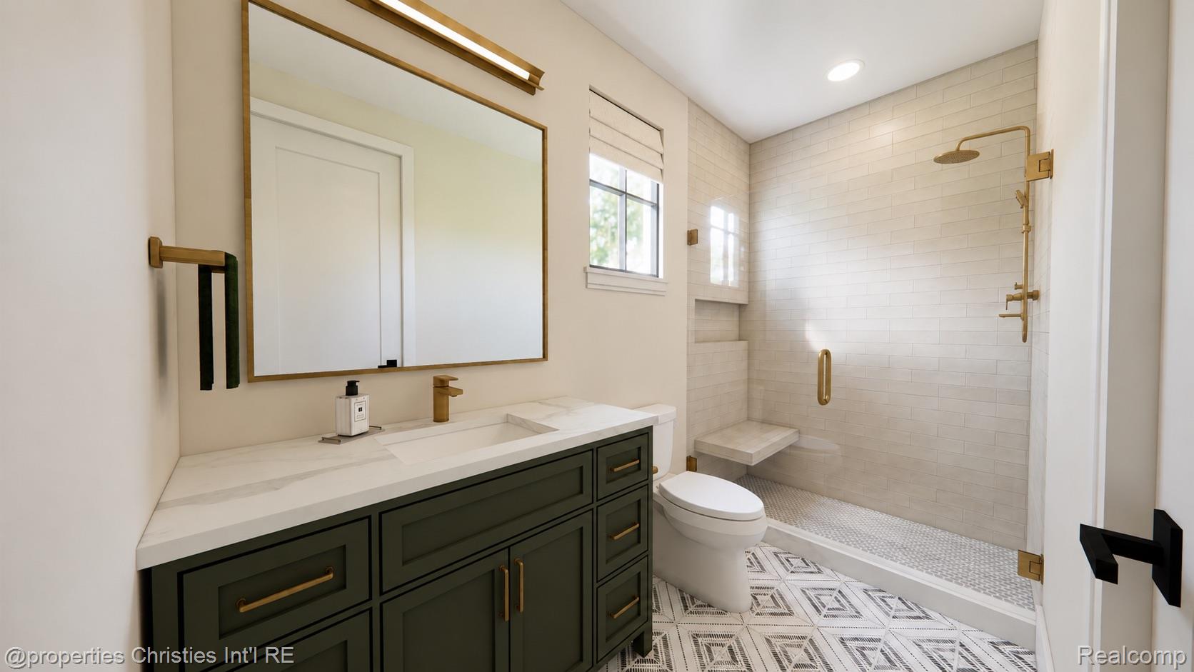 Bathroom with a dark green vanity and a white-tiled walk-in shower with brass fixtures.