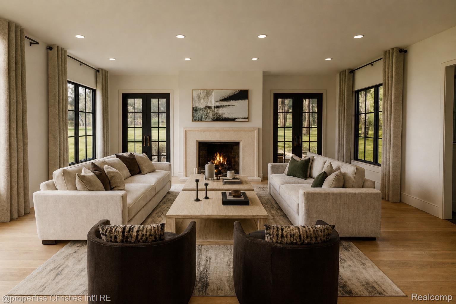 Living room with cream sofas, dark armchairs, and a lit fireplace between black-framed French doors.