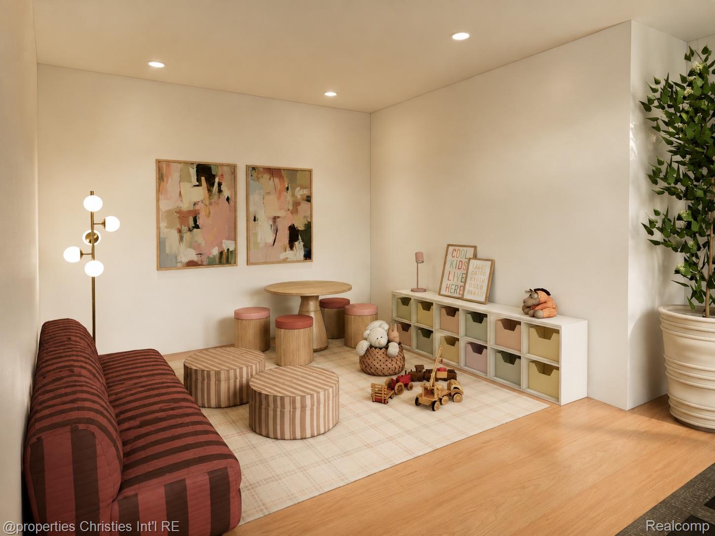 Children’s playroom with a striped sofa, wooden play table, toy cubbies, and scattered toys.