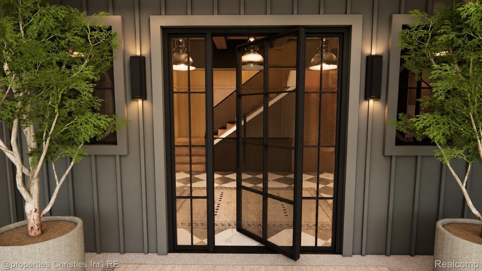 Home entrance with an open black-framed glass door, flanked by potted trees and gray siding.