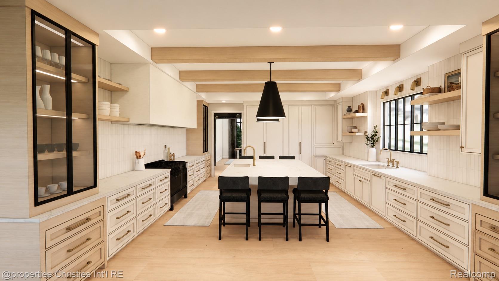 Kitchen with a large island, three black stools, white cabinetry, and light wood ceiling beams.