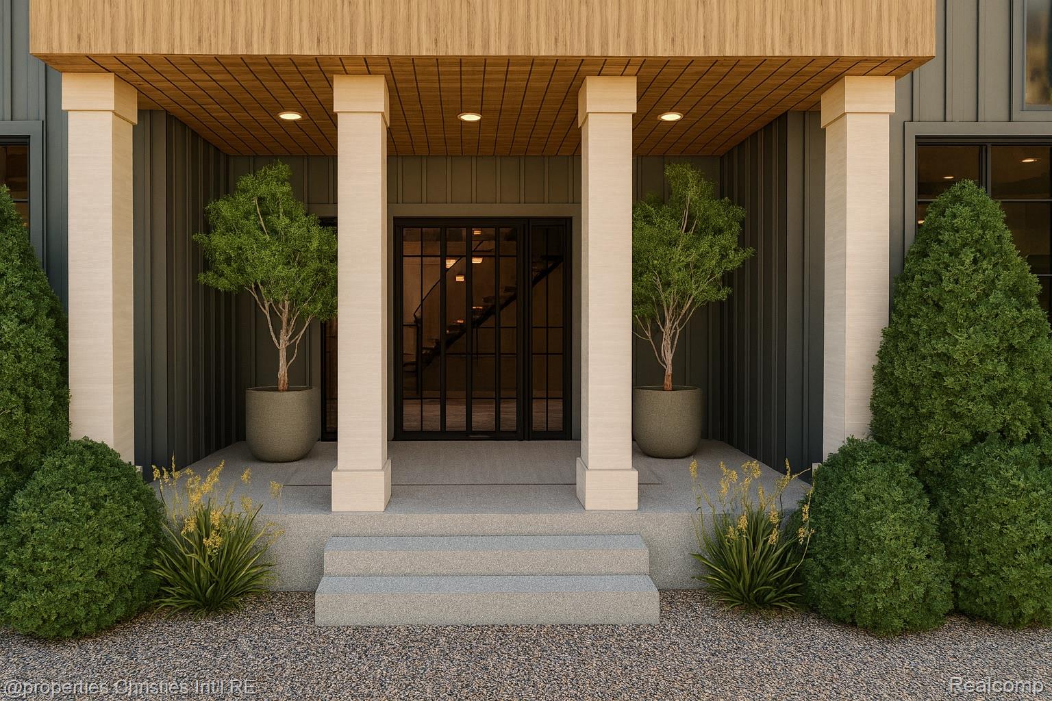 Modern home entrance with a wood-paneled canopy, pale columns, black-framed doors, and landscaped steps.
