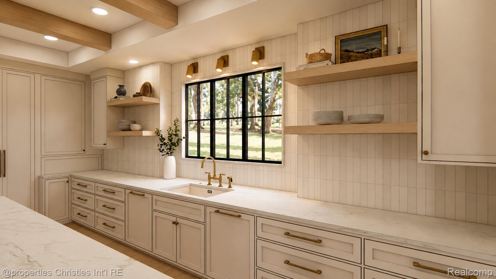 Kitchen with cream cabinetry, brass fixtures, open wood shelves, and a black-framed window overlooking trees.