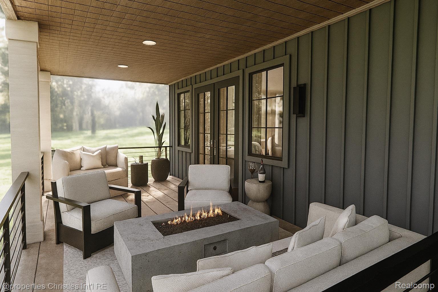Covered patio with light seating, potted plants, and a rectangular concrete fire table.