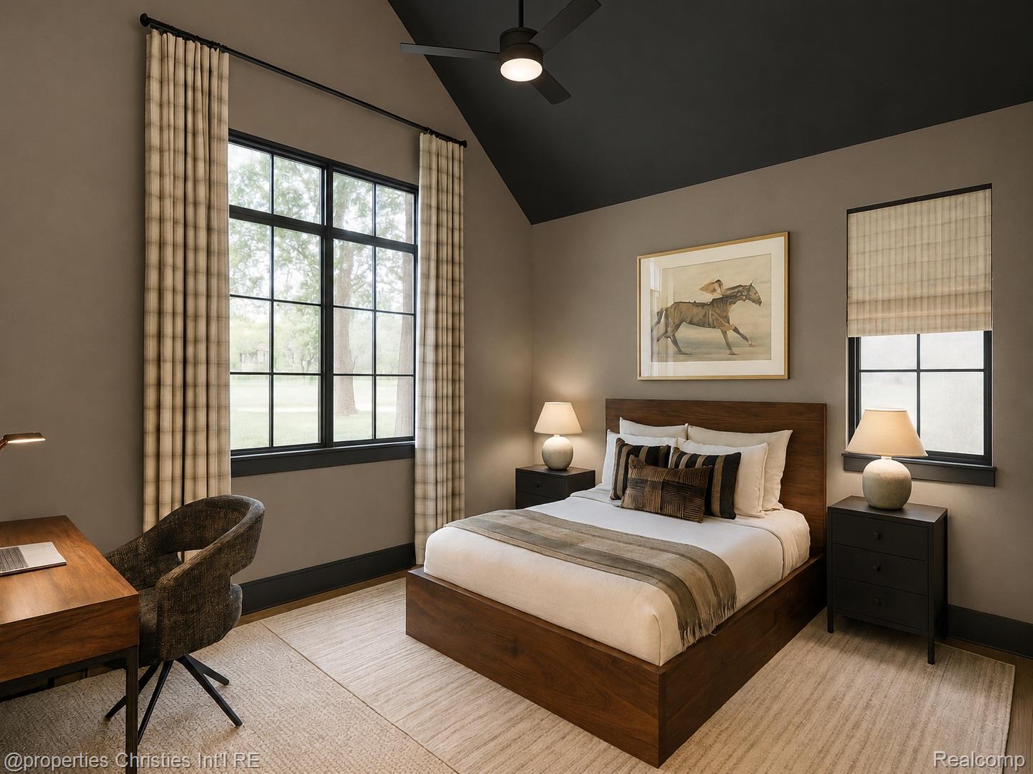 Bedroom with a dark wood bed, vaulted ceiling, and tall curtained windows.