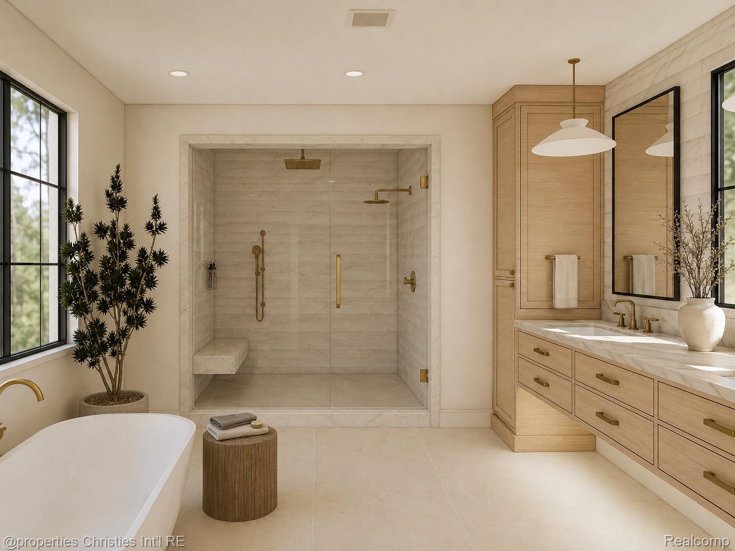 Bathroom with a marble walk-in shower, freestanding tub, and light wood vanity.